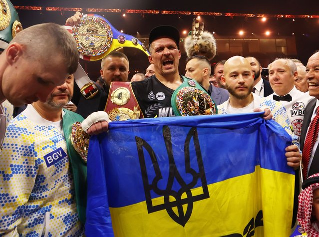 Oleksandr Usyk holds a Ukrainian flag as he celebrates with the Undisputed Heavyweight title belt following victory over Tyson Fury (not pictured) in the IBF, WBA, WBC, WBO and Undisputed Heavyweight titles' fight between Tyson Fury and Oleksandr Usyk at Kingdom Arena on May 18, 2024 in Riyadh, Saudi Arabia. (Photo by Richard Pelham/Getty Images)