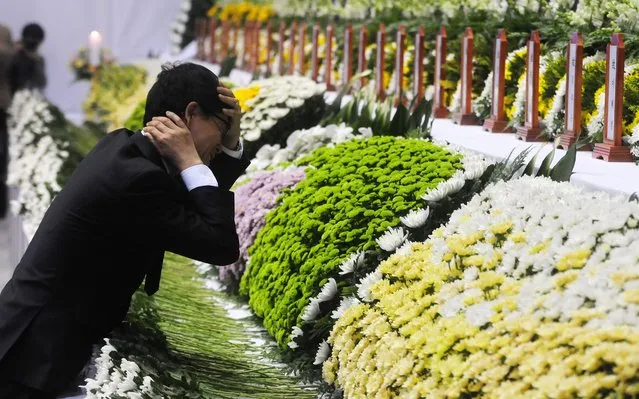 A grief-fuelled moment for a father of a victim of the Sewol ferry accident, at a joint incense-burning altar set up at Ansan Olympic Memorial Hall in Ansan, south of Seoul, South Korea. 23 April 2014. Officials say about 200 people are still missing and at least 150 confirmed dead after a passenger ferry carrying hundreds of teenagers sank off the southern coast of South Korea on 16 April. Only 179 of 475 passengers and crew were rescued. (Photo by Yang Ji-Woong/EPA)