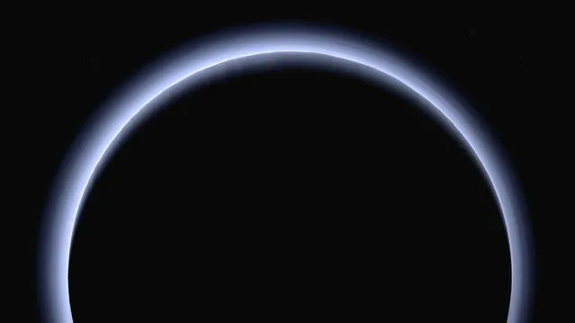 This image made available by NASA in March 2017 shows Pluto illuminated from behind by the sun as the New Horizons spacecraft travels away from it at a distance of about 120,000 miles (200,000 kilometers). On Friday, April 7, 2017, the spacecraft will reach a halfway between Pluto and its next much, much smaller stop, the Kuiper Belt object 2014 MU69. (Photo by NASA/Johns Hopkins University Applied Physics Laboratory/Southwest Research Institute via AP Photo)
