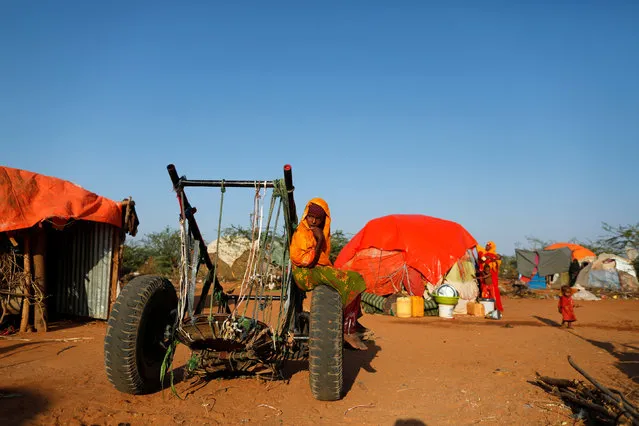 Zeinab's sister Farhiya, 6, sits on a cart near her family's shelter at a camp for internally displaced people from drought hit areas in Dollow, Somalia April 4, 2017. (Photo by Zohra Bensemra/Reuters)
