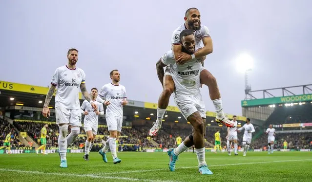 Ivan Toney of Brentford celebrates with teammate Bryan Mbeumo after scoring their side's third goal from the penalty spot and their hat-trick during the Premier League match between Norwich City and Brentford at Carrow Road on March 05, 2022 in Norwich, England. (Photo by Julian Finney/Getty Images)