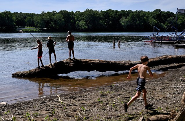 The White's Ferry boat launch ramp area is a popular place for locals to enjoy the cool waters of the Potomac River in Poolesville, Maryland on June 19, 2024. Kids fishing, swimmers  and boaters all shared the waters as temperatures have been quite warm for several days. (Photo by Michael S. Williamson/The Washington Post) 