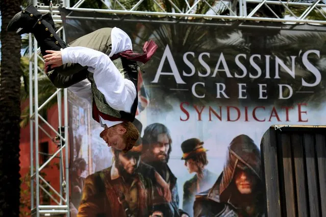 A performer does a flip during an obstacle course at the “Assassin's Creed Syndicate” booth outside of the 2015 Comic-Con International in San Diego, California July 10, 2015. (Photo by Sandy Huffaker/Reuters)