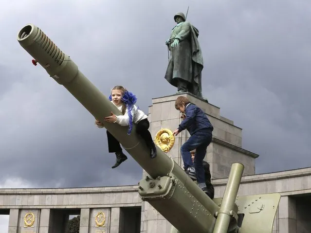 Children play on a historical Soviet cannon during celebrations to mark Victory Day at a Soviet War Memorial in Berlin, on May 9, 2014. (Photo by Fabrizio Bensch/Reuters)