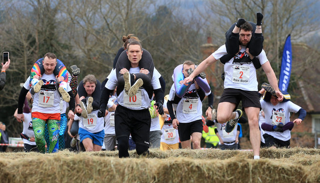 Marriages were put to the test over the weekend at the annual UK Wife Carrying Race in Dorking, Surrey, United Kingdom on March 5, 2023. The Lithuanian pair of Vytautas and Neringa Kirkliauskiene won. (Photo by Peter Tarry/The Times)