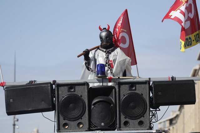 A man wearing a costume rides on a CGT union truck during a rally against the government's reform to the pension system in Marseille, France, 06 April 2023. Protests continue in France after the prime minister announced on 16 March 2023 the use of Article 49 paragraph 3 (49.3) of the French Constitution to have the text on the controversial pension reform law – raising retirement age from 62 to 64 – be definitively adopted without a vote. The members of the Constitutional Council, are due to give their decision on 14 April concerning the examination of the text of the pension reform. (Photo by Guillaume Horcajuelo/EPA/EFE)