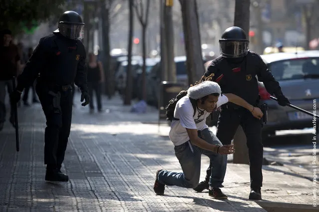 Riot Police clash with student demonstrators during a demonstration on February 2012 in Barcelona