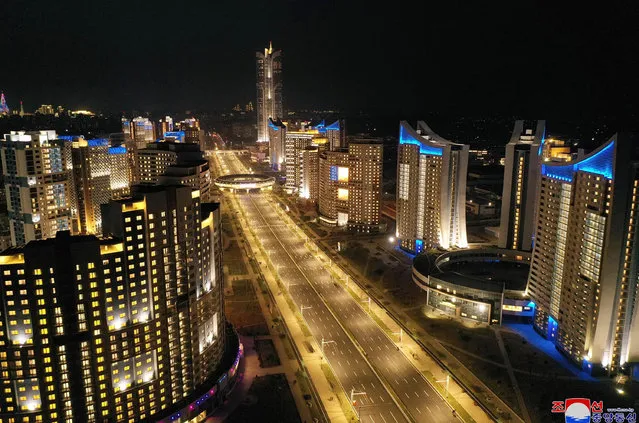 This picture taken on April 11, 2022 and released from North Korea's official Korean Central News Agency (KCNA) on April 12 shows a night view of Pyongyang's Songhwa Street. (Photo by KCNA via KNS/AFP Photo)