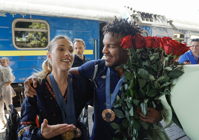 Women's Sabre Gold medalist Olga Kharlan (L) and bronze medalist in the Men's Greco-Roman Wrestling Zhan Beleniuk (R) react as they arrive at the railway station in Kyiv, Ukraine, 13 August 2024. Ukrainians meet and greet the members of National Olympic team as they return from Olympic Games 2024 in Paris amid the ongoing Russian invasion. (Photo by Sergey Dolzhenko/EPA/EFE)