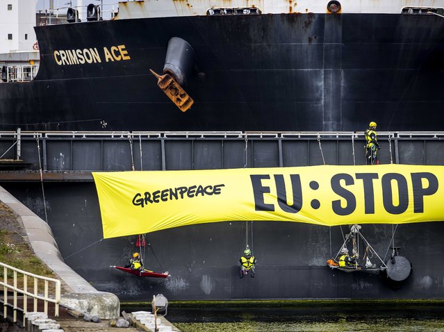 Activists from Europe and Brazil with Greenpeace Netherlands have blocked the Noordersluis, as a result, a 225 meter long ship, the Crimson Ace, is now stuck in the lock in IJmuiden, the Netherlands, 11 May 2022. The Crimson Ace has 60 million kilos of soy from Brazil on board. (Photo by Koen van Weel/EPA/EFE)
