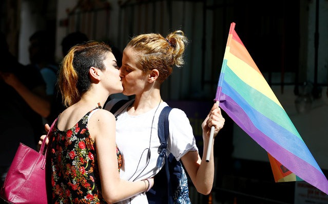 LGBT rights activists kiss during a transgender pride parade which was banned by the governorship, in central Istanbul, Turkey, June 19, 2016. (Photo by Osman Orsal/Reuters)