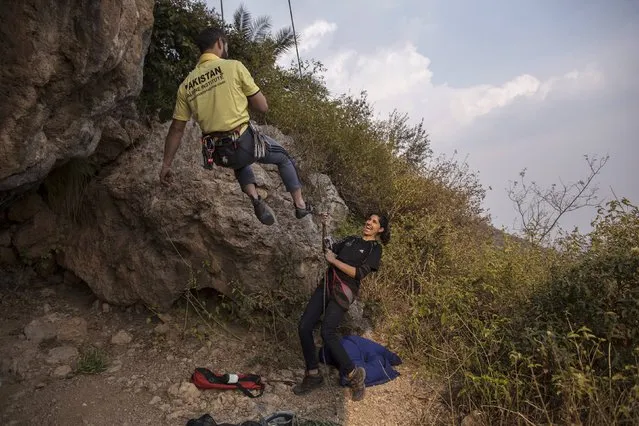 Rock climber Nazia Parveen (R) jokes with her trainer Imran Junaidi during their practice in Islamabad February 15, 2014. (Photo by Zohra Bensemra/Reuters)