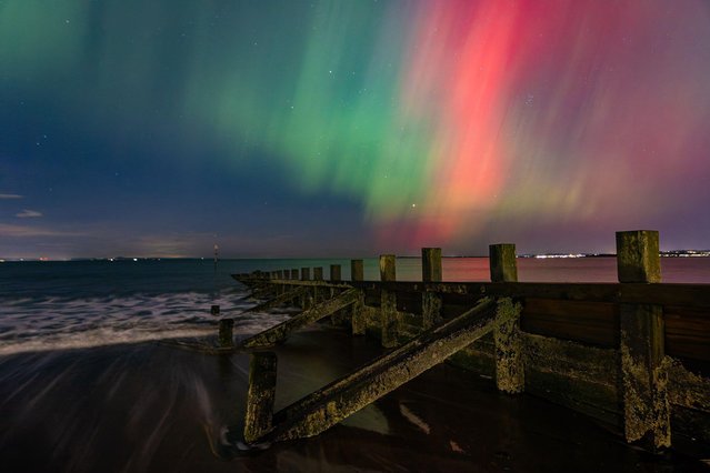 The Northern Lights visible over a groyne on the beach at Portobello near Edinburgh, United Kingdom on October 10, 2024. The Aurora Borealis (or Northern Lights) was visible over much of the United Kingdom. (Photo by Rich Dyson/Alamy Live News)