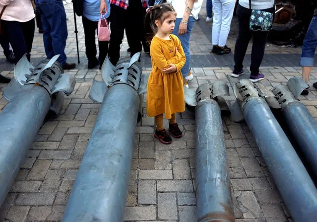 A girl looks on at a display of Russian weapon systems used in their attacks, outside St Michael's Cathedral, as Russia's attack on Ukraine continues, in Kyiv, Ukraine on May 29, 2022. (Photo by Edgar Su/Reuters)