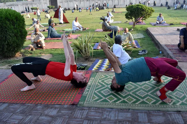 Participants take part in a yoga performance in Lahore, Pakistan, on June 20, 2022. The International Day of Yoga is celebrated annually on June 21. (Photo by Xinhua News Agency/Rex Features/Shutterstock)