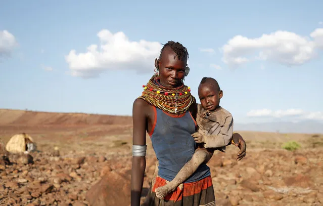 A Turkana tribeswoman holds her child in a village near Loiyangalani, Kenya August 4, 2017. (Photo by Goran Tomasevic/Reuters)