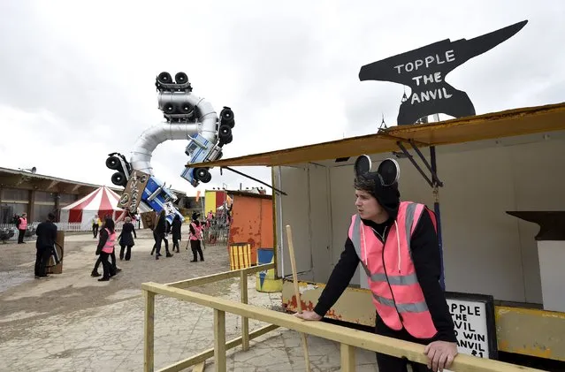 A performer stands at a booth at “Dismaland”, a theme park-styled art installation by British artist Banksy, at Weston-Super-Mare in southwest England, Britain, August 20, 2015. (Photo by Toby Melville/Reuters)