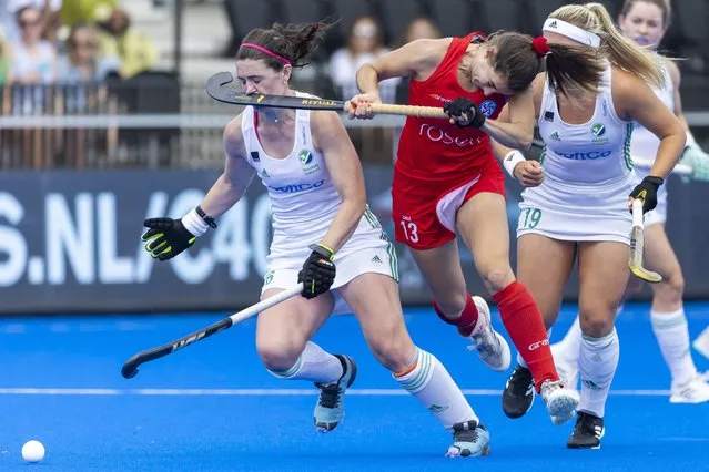 Ireland's Roisin Upton (L) gets a stick to the face during a duel with Chile's Camila Caram during the hockey match between Ireland and Chile at the World Hockey Championships at the Wagener stadium, in Amsterdam, on July 5, 2022. (Photo by Willem Vernes/ANP via AFP Photo)