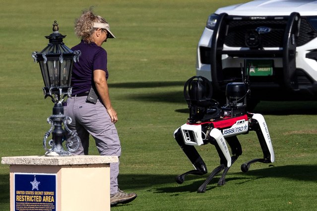 A Secret Service officer interacts with a robot dog at President-elect Donald Trump's residence at Mar-a-Lago in Palm Beach, Florida on November 12, 2024. (Photo by Carlos Barria/Reuters)