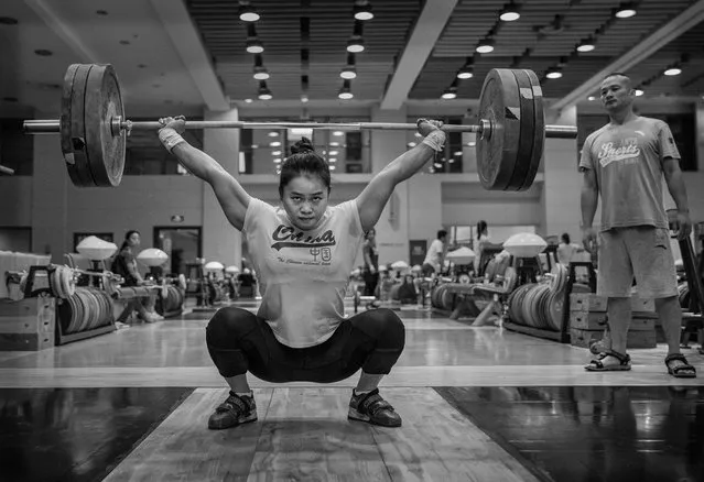 Chinese female weightlifter Deng Wei, who competes in the 63 kg weightclass, lifts during a training session in preparation for the Rio Olympics at the Training Center of General Administration of Sports in China on July 20, 2016 in Beijing, China. Deng Wei won the World Championships in 2010 and 2015. (Photo by Kevin Frayer/Getty Images)