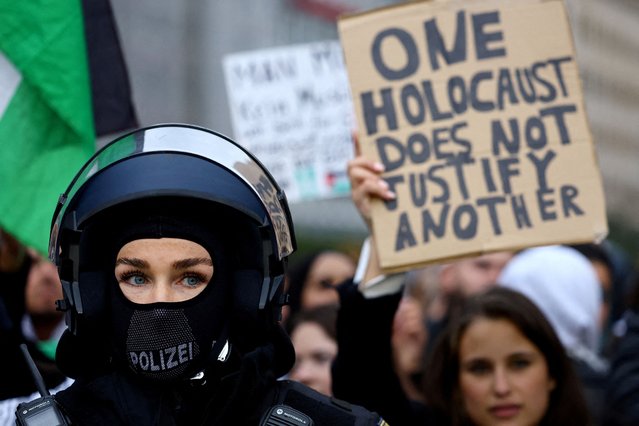 A police officer stands guard during a pro-Palestinian demonstration as the conflict between Israel and Hamas continues, in Frankfurt, Germany on October 18, 2023. (Photo by Kai Pfaffenbach/Reuters)