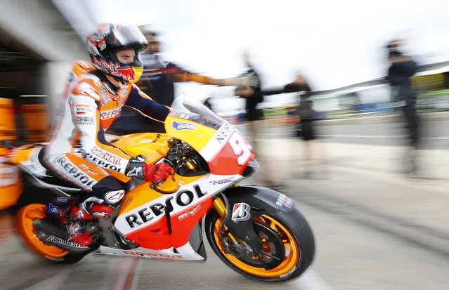 Honda MotoGP rider Marc Marquez of Spain exits his garage during the third practice session for the British Grand Prix at the Silverstone Race Circuit, central England, August 30, 2014. (Photo by Darren Staples/Reuters)