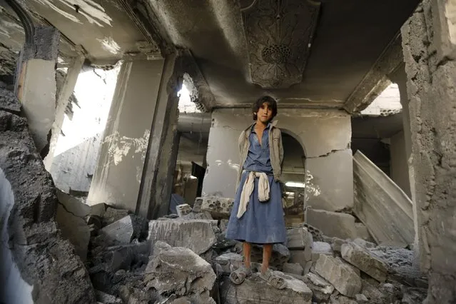 A boy stands in Houthi leader Yahya Aiydh's house, after Saudi-led air strikes destroyed it in Yemen's capital Sanaa September 8, 2015. A Saudi-led alliance has deployed 10,000 troops to Yemen, Qatari news channel Al Jazeera said on Tuesday, in an apparent sign of determination to rout Iran-allied Houthi forces after they killed at least 60 Gulf Arab soldiers on Friday. (Photo by Khaled Abdullah/Reuters)