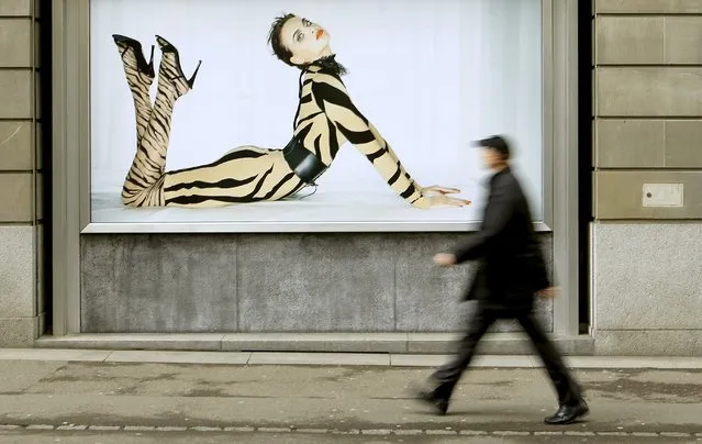 A man walks past an advertising poster of Austrian luxury hosiery group Wolford AG in Zurich, Switzerland in this March 8, 2012 file photo. Wolford is expected to report Q1 results this week. (Photo by Arnd Wiegmann/Reuters)
