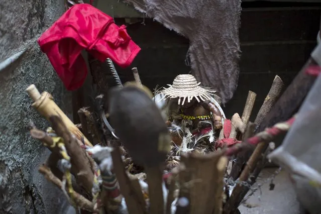 Santeria's sacred symbols are seen in a house during a ceremony to attract spirits of dead ancestors to ask for guidance in downtown Havana, August 18, 2015. (Photo by Alexandre Meneghini/Reuters)