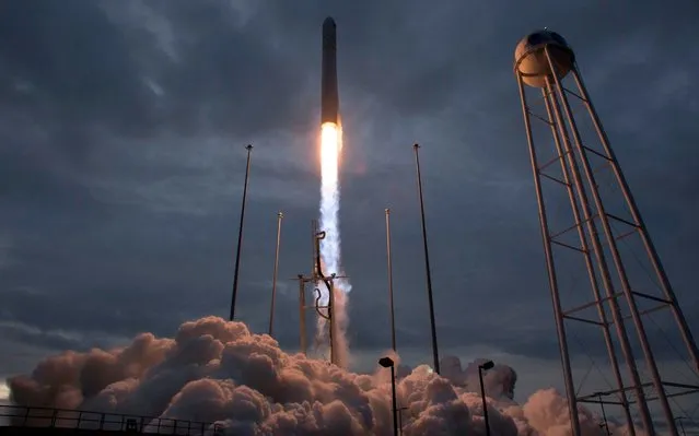 In this image released by NASA, the Orbital ATK Antares rocket, with the Cygnus spacecraft onboard, launches from Pad-0A, on November 12, 2017, at NASA' s Wallops Flight Facility in Virginia. Cygnus is packed with 7,400 pounds (3,350 kilograms) of food and supplies for the astronauts living in the International Space Station. The cargo ship is also transporting 14 miniature satellites, known as CubeSats. Cygnus should arrive at the orbiting outpost on November 14. (Photo by Bill Ingalls/AFP Photo/NASA)