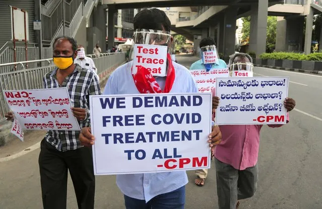 Activists of Communist Party of India Marxist wearing face shields and hold placards during a protest asking the state government to increase testing and free treatment for all COVID-19 patients in Hyderabad, India, Monday, June 29, 2020. Governments are stepping up testing and warily considering their next moves as the number of newly confirmed coronavirus cases surges in many countries. India reported more than 20,000 new infections on Monday. (Photo by Mahesh Kumar A./AP Photo)