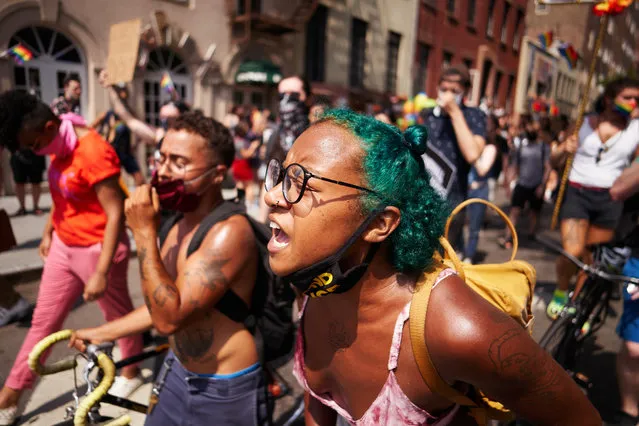 People march by the Stonewall Inn on the 51st anniversary of the 1969 Stonewall Inn riots in Greenwich Village on Sunday, June 28, 2020 in New York, N.Y.   (James Keivom/The New York Post)