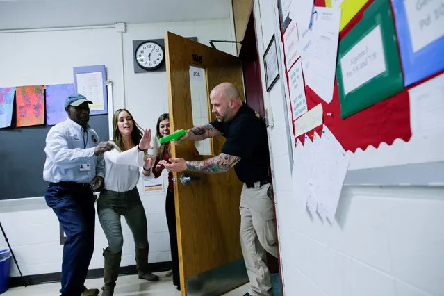 Teachers and staff members take part in an active shooter training at James I O'Neill High School in Highland Falls, New York, U.S., December 12, 2017. (Photo by Eduardo Munoz/Reuters)