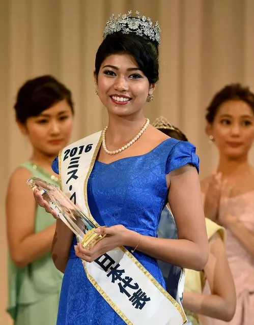 Priyanka Yoshikawa smiles as she holds the trophy after winning the Miss Japan title during the Miss World Japan 2016 Beauty Pageant in Tokyo on September 5, 2016. The half-Indian twenty-two year-old model won the title to represent Japan for Miss World 2016. (Photo by Toru Yamanaka/AFP Photo)