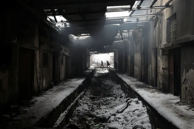 Migrants walk during a snowfall inside a derelict customs warehouse in Belgrade, Serbia, January 11, 2017. (Photo by Marko Djurica/Reuters)