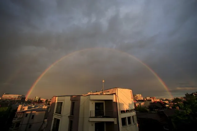 A double rainbow is seen over buildings after rain in Bucharest, Romania May 3, 2015. (Photo by Radu Sigheti/Reuters)