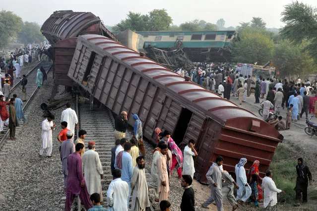 Locals gather at the scene where two trains collided near Multan, Pakistan September 15, 2016. (Photo by Khalid Chaudry/Reuters)
