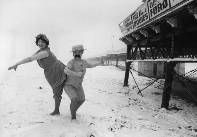Skegness landladies Hazel Adams and Marjorie Romanis wearing 1914 bathing costumes on the beach in the snow for publicity photographs, circa 1975. (Photo by Ian Tyas/Keystone Features/Getty Images)