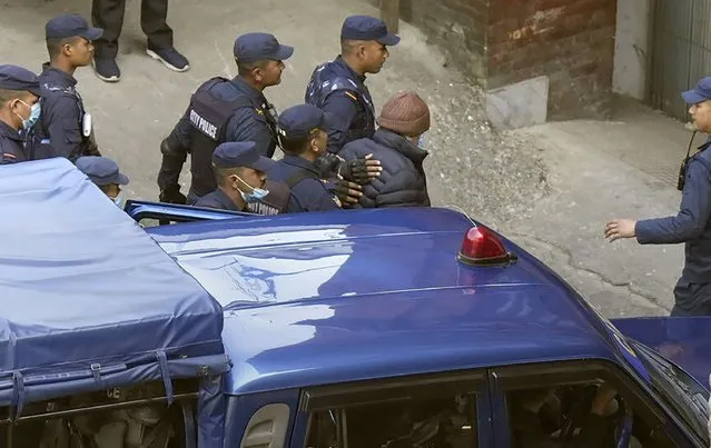 Nepalese police escort Charles Sobhraj, in brown cap, to the immigration office, in Kathmandu, Nepal, Friday, December 23, 2022. Confessed French serial killer Charles Sobhraj has been released from prison in Nepal after serving most of his sentence. Sobhraj was driven out of Central Jail in Kathmandu to the Department of Immigration under heavy guard Friday after the Supreme Court ordered him to be released because of poor health and good behavior. (Photo by Niranjan Shrestha/AP Photo)