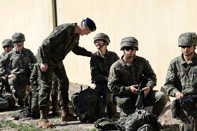 A handout photo made available on 18 March 2024 by the Spanish Royal Household shows Spain's King Felipe VI (C-L) talking to his eldest daughter, Crown Princess Leonor (C-R) as she takes part in maneuvers and combat exercises along with the Spanish General Military Academy's cadets at the San Gregorio National Military Training Center, outside Zaragoza, northeastern Spain, 15 March 2024. (Photo by Francisco Gomez/EPA/EFE)