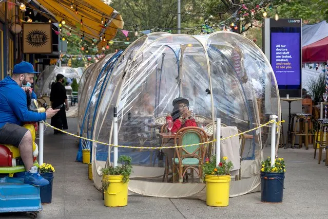 A woman dines in a “social distancing bubble” at Cafe Du Soleil as the city continues Phase 4 of re-opening following restrictions imposed to slow the spread of coronavirus on September 28, 2020 in New York City. The fourth phase allows outdoor arts and entertainment, sporting events without fans and media production. (Photo by Alexi Rosenfeld/Getty Images)