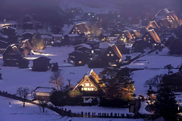 This general view shows the “Gassho-Zukuri” village houses lit up in the snow-covered Shirakawa-go in Gifu prefecture, central Japan on January 15, 2023. (Photo by JIJI Press via AFP Photo)