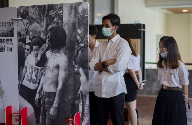 University students view an exhibition of a student massacre over 40 years ago at the Thammasat University, in Bangkok, Thursday, October 1, 2020. Academics and researchers say they’re seeing a surge in the number of people wanting to learn about a massacre of protesting students 44 years ago by security forces and right-wing vigilantes that mainstream Thai history books ignore. Some welcome this quest for knowledge, others say they are being manipulated. (Photo by Gemunu Amarasinghe/AP Photo)