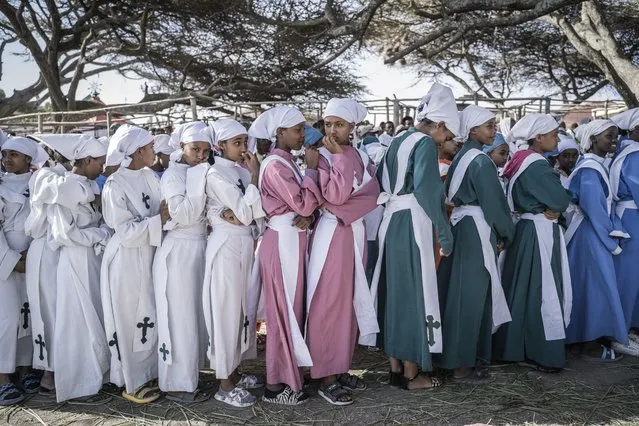 Ethiopian Orthodox devotees attend a prayer during the celebration of the Ethiopian Epiphany on the shore of lake Ziway, also known as lake Dembel, Ethiopia, on January 19, 2023. (Photo by Amanuel Sileshi/AFP Photo)