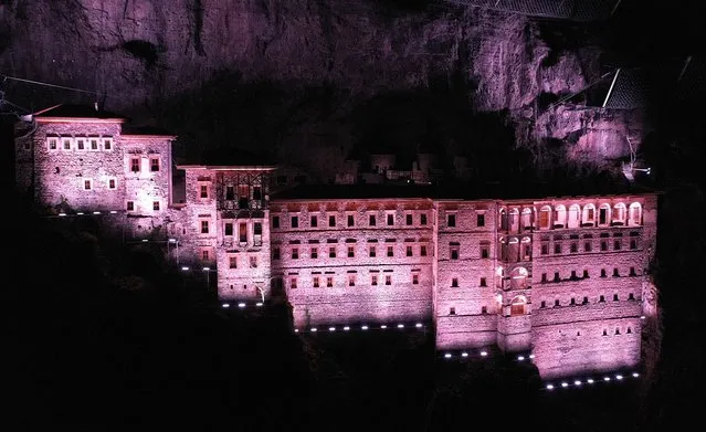Sumela Monastery is illuminated with light during the winter season in Trabzon, Turkiye on January 24, 2023. The monastery, which is included in UNESCO's temporary list of World Heritage sites, was reopened for religious practice on Aug. 15, 2010, with permission from the Culture and Tourism Ministry, following an 88-year hiatus. The Greek-Orthodox monastery dedicated to the Virgin Mary was built by carving the rocks as a nestling in a steep cliff at an altitude of about 1.200 meters facing the Altindere valley of Karadag. (Photo by Hakan Burak Altunoz/Anadolu Agency via Getty Images)