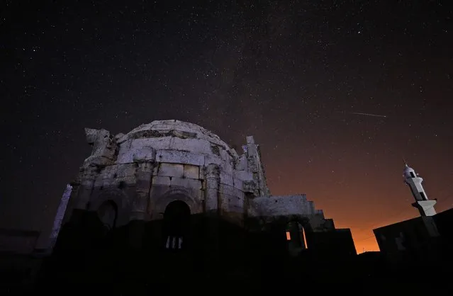 The Milky Way rises on July 29, 2022, above the 5th century basilica of Syria's Qalb Lozeh village in the northwestern Idlib province. The ancient lime-stone cathedral is the architectural forerunner of France's famed Notre Dame cathedral. The abandoned church is widely hailed as Syria's finest example of Byzantine-era architecture and is considered to have inspired Romanesque and Gothic cathedrals in Europe, including the Paris landmark. (Photo by Omar Haj Kadour/AFP Photo)