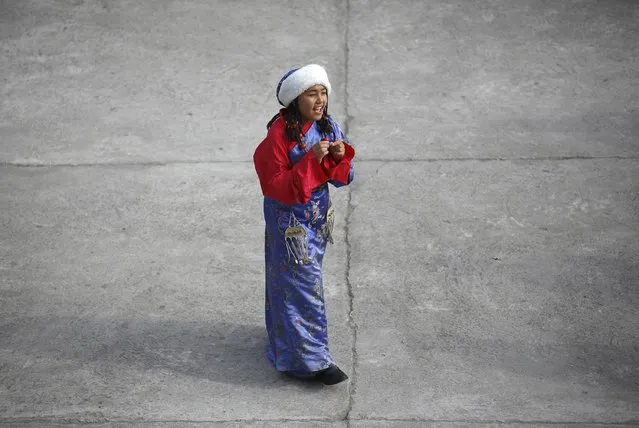 A Tibetan girl in traditional attire takes part during a function organised by the Tibetan Refugee Community in Nepal, commemorating the 25th Anniversary of the Nobel Peace Prize conferment to exiled Tibetan spiritual leader Dalai Lama and the 66th International Human Rights Day in Kathmandu December 10, 2014. (Photo by Navesh Chitrakar/Reuters)