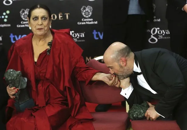 Actor Javier Camara, winner of the Best Leading Actor award, kisses the hand of actress Terele Pavez, who won the Best Supporting Actress award, during a family photo at the Spanish Film Academy's Goya Awards ceremony in Madrid, in this February 10, 2014 file photo. (Photo by Javier Barbancho/Reuters)