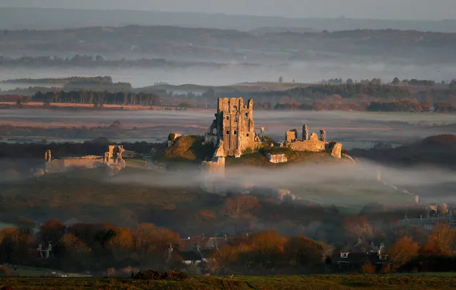 The rising sun lights up Corfe Castle in Dorset, England on November 19, 2017. (Photo by Andrew Matthews/PA Images via Getty Images)