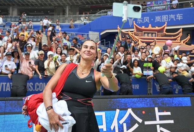 Belarus' Aryna Sabalenka takes a selfie photo with fans after winning against Kazakhstan's Elena Rybakina during their women's singles quarterfinal match at the Wuhan Open tennis tournament in Wuhan, Central China's Hubei province on October 10, 2025. (Photo by Adek Berry/AFP Photo)